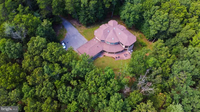 a kitchen with kitchen island granite countertop a table chairs sink and cabinets