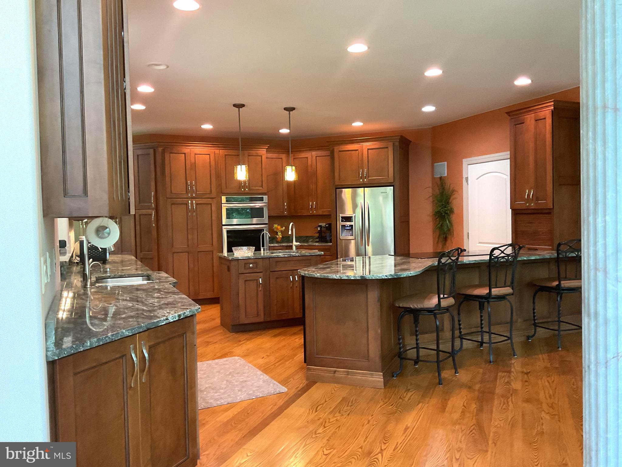 13200 Crossover Road Northeast Flintstone, MD 21530 - Photo 30 of 60 a kitchen with kitchen island granite countertop a table chairs sink and cabinets