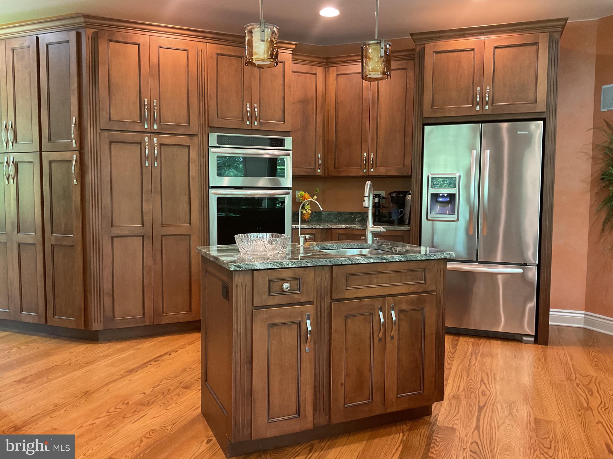 13200 Crossover Road Northeast Flintstone, MD 21530 - Photo 44 of 60 a kitchen with stainless steel appliances granite countertop a refrigerator a stove and a sink with wooden cabinets
