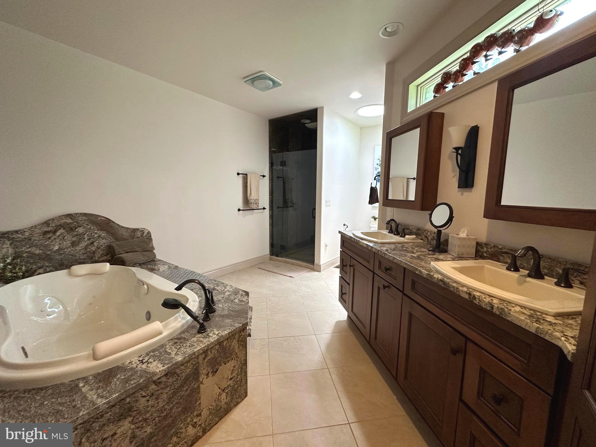 13200 Crossover Road Northeast Flintstone, MD 21530 - Photo 49 of 60 a spacious bathroom with a granite countertop tub sink and mirror