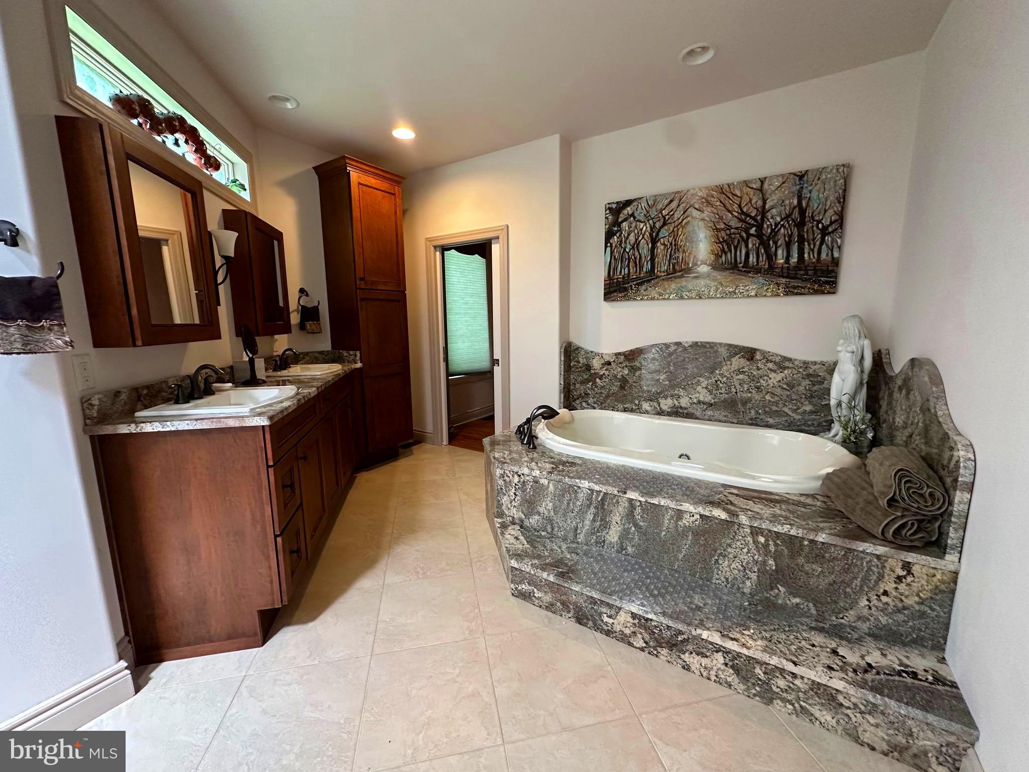 13200 Crossover Road Northeast Flintstone, MD 21530 - Photo 50 of 60 a spacious bathroom with a tub a mirror and sink