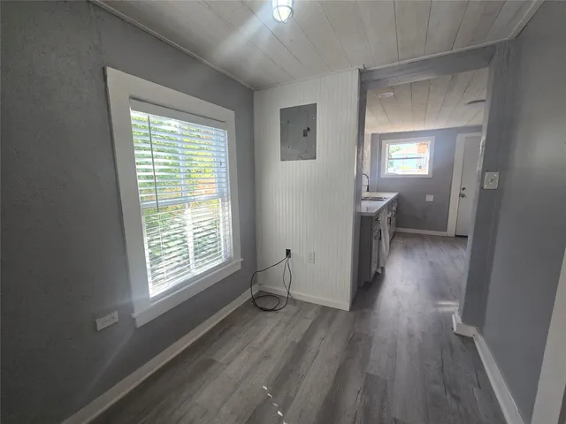 a view of a room with wooden floor and a window