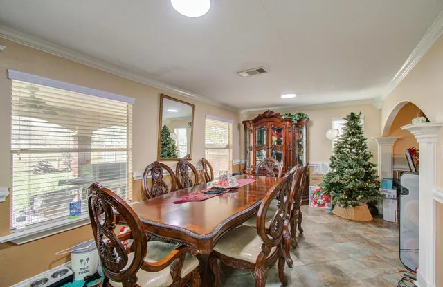 a dining room with furniture and window