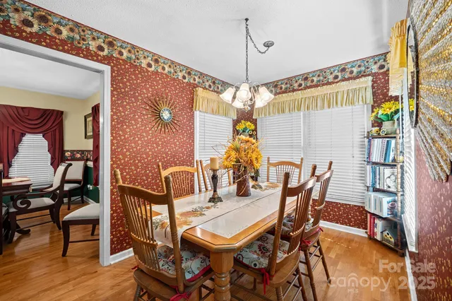 a dining room with furniture and wooden floor
