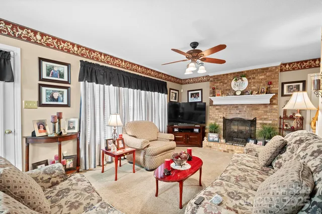 a living room with furniture a fireplace and a flat screen tv