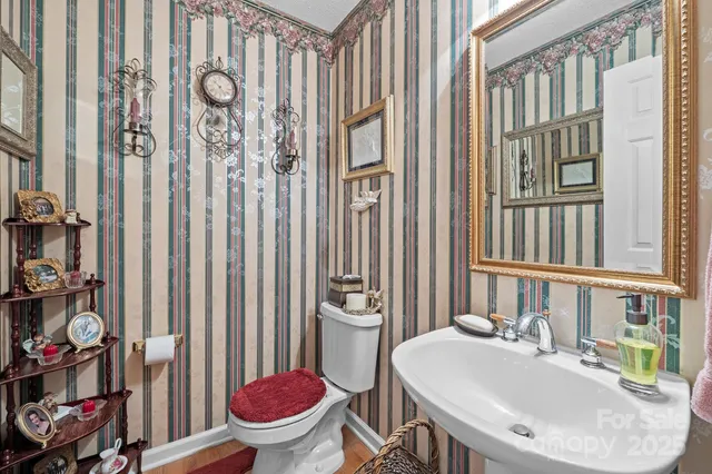 a bathroom with a sink toilet and a mirror