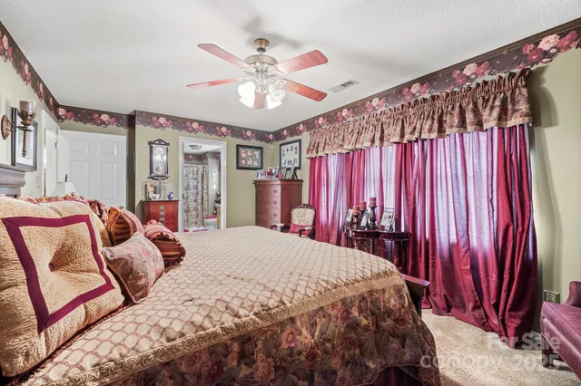 a bed sitting in a bedroom next to a window