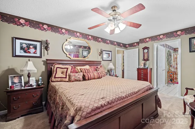 a bedroom with a large bed and a chandelier