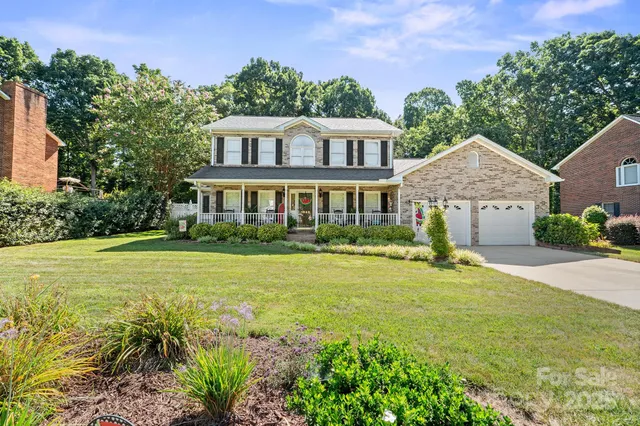 a front view of a house with swimming pool having outdoor seating