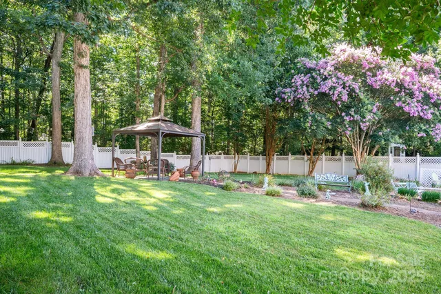 a view of a house with backyard and sitting area