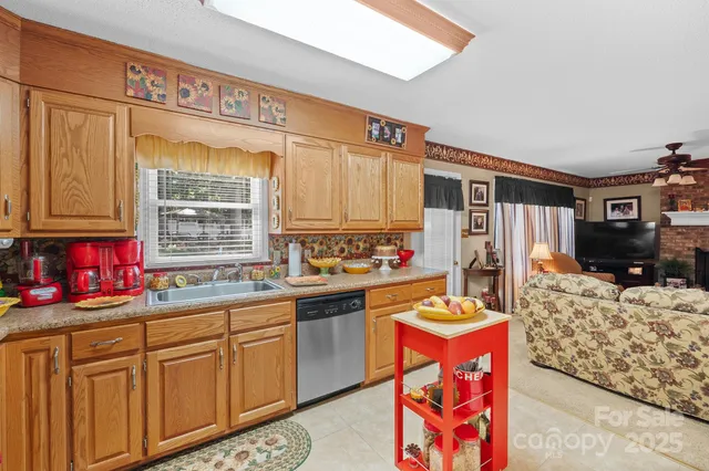 a kitchen with stainless steel appliances kitchen island granite countertop a refrigerator and a stove top oven