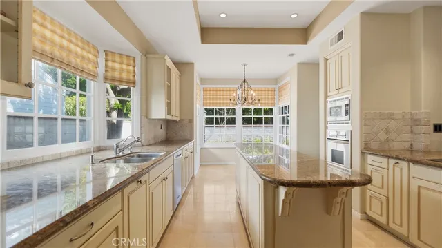 a kitchen with granite countertop a stove and a sink