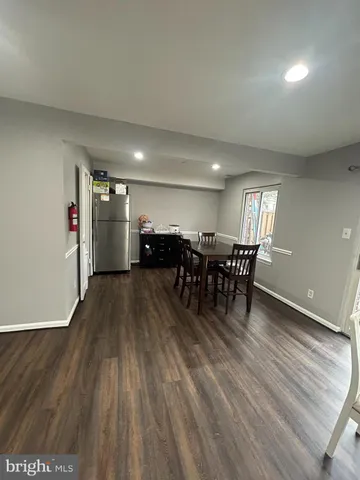 a view of a room with furniture wooden floor and chandelier