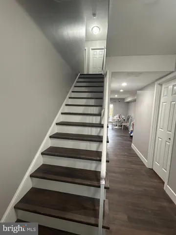 a view of entryway and hall with wooden floor