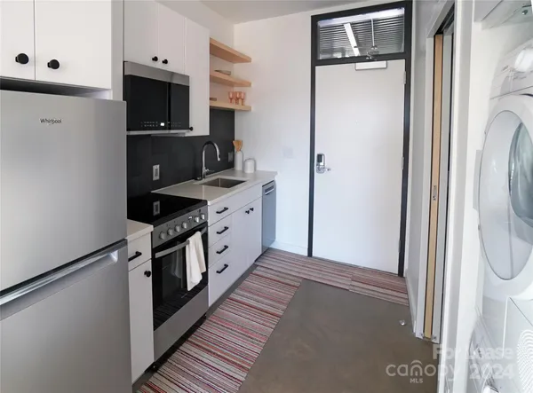 a kitchen with stainless steel appliances a refrigerator sink and stove