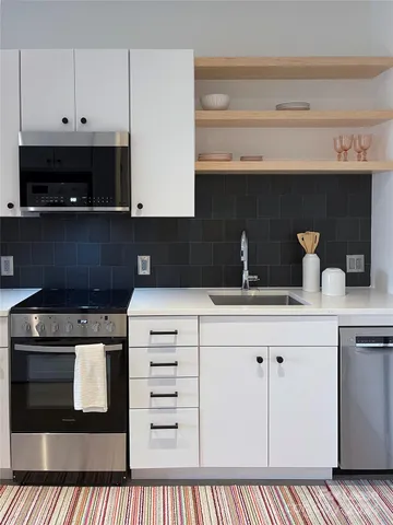 a kitchen with a stove and a microwave