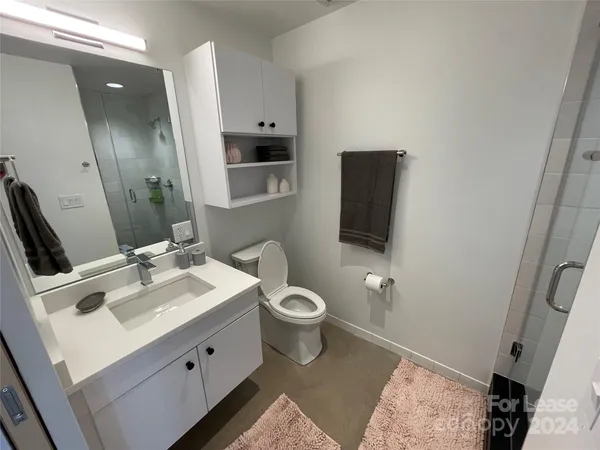 a bedroom with a bed and a view of bathroom