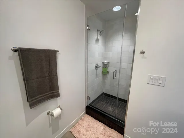 a bedroom with furniture and a flat screen tv