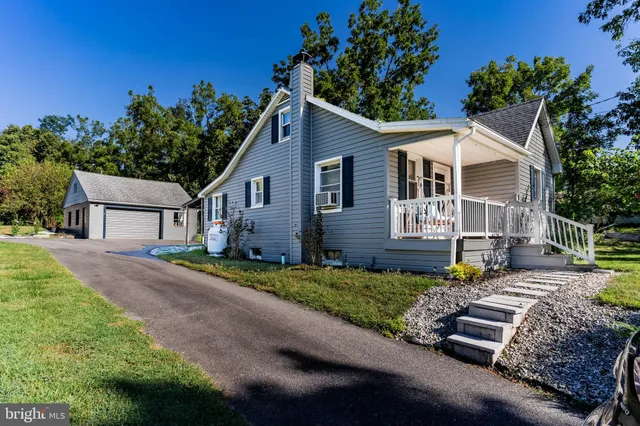 a front view of a house with a yard and a garage
