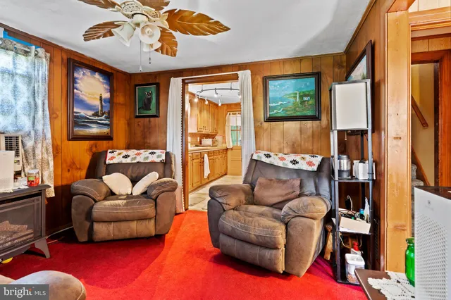 a living room with furniture a rug and a chandelier