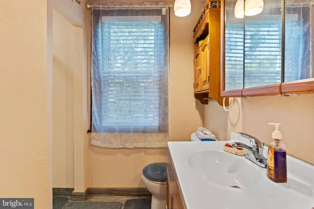 a bathroom with a sink a toilet and tub