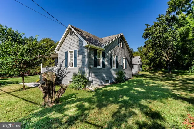 a front view of house with a garden
