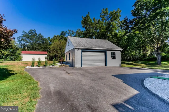 a aerial view of a house with swimming pool and next to a yard