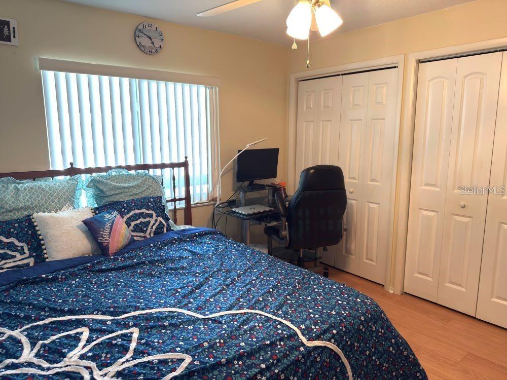 108 Nina Way, Unit 3 Oldsmar, FL 34677 - Photo 14 of 25 a bedroom with a large bed and a chandelier