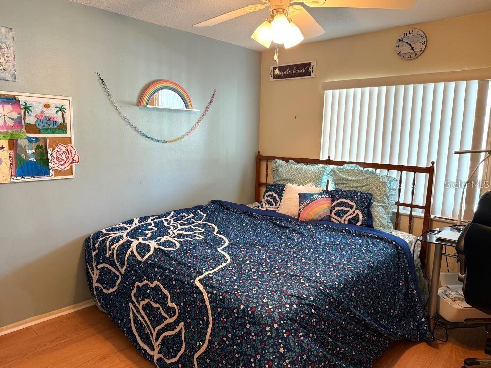 108 Nina Way, Unit 3 Oldsmar, FL 34677 - Photo 15 of 25 a bedroom with a bed and a chandelier