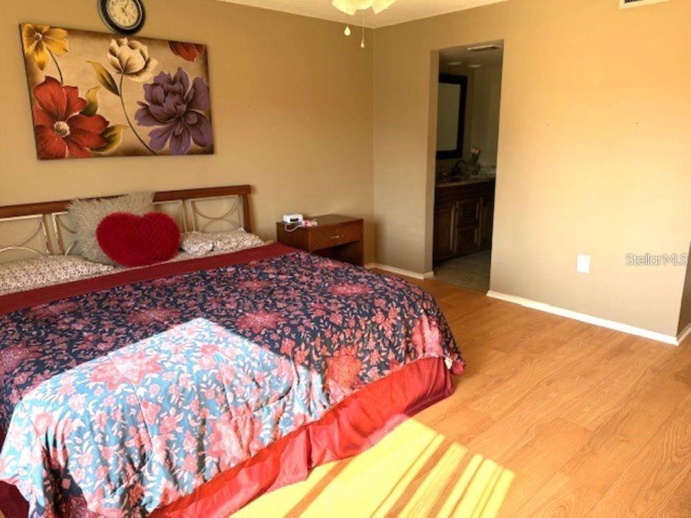 108 Nina Way, Unit 3 Oldsmar, FL 34677 - Photo 16 of 25 a bedroom with a bed and a painting on the wall