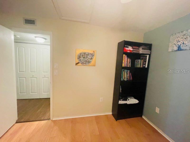 108 Nina Way, Unit 3 Oldsmar, FL 34677 - Photo 17 of 25 a room with a wooden floor and shoes