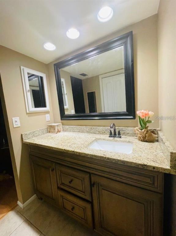 108 Nina Way, Unit 3 Oldsmar, FL 34677 - Photo 19 of 25 a bathroom with a granite countertop sink a large mirror and