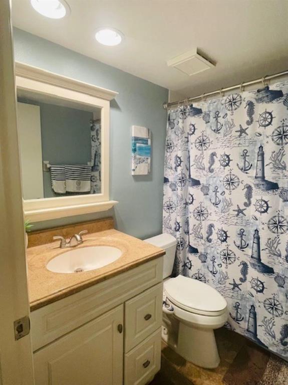 108 Nina Way, Unit 3 Oldsmar, FL 34677 - Photo 21 of 25 a bathroom with a granite countertop toilet and a sink