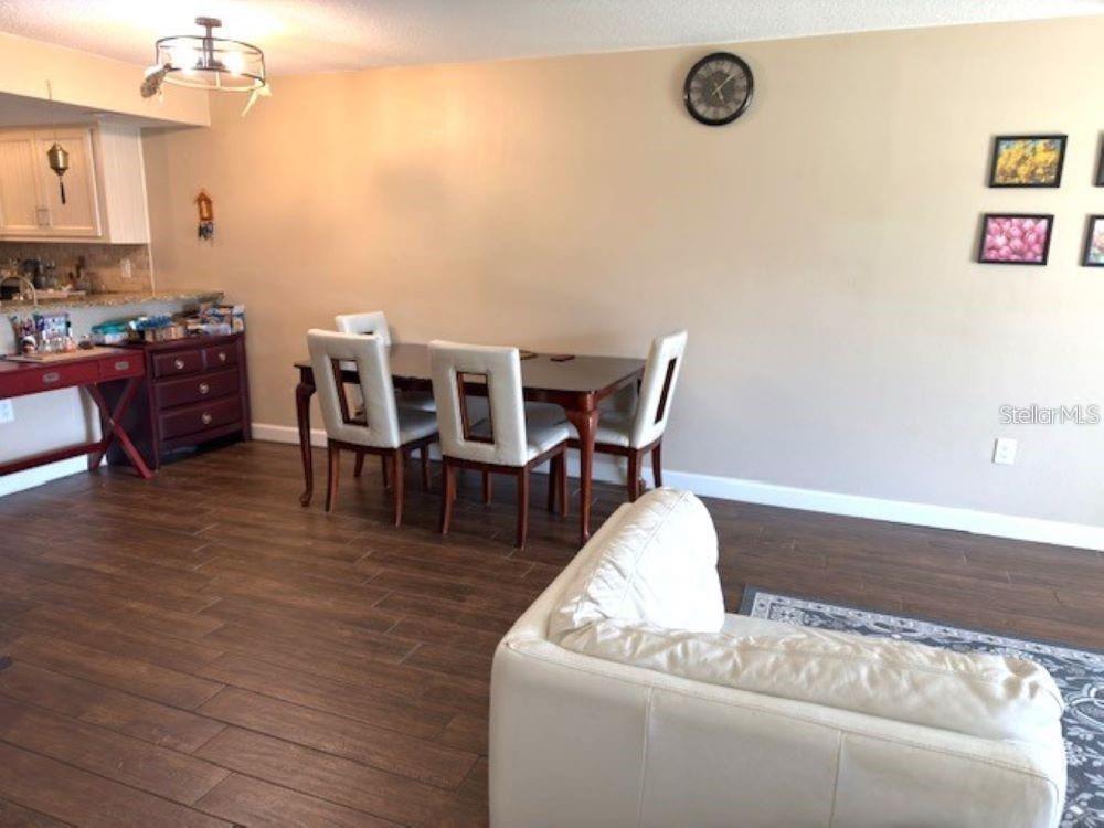 108 Nina Way, Unit 3 Oldsmar, FL 34677 - Photo 5 of 25 a living room with furniture and a wooden floor