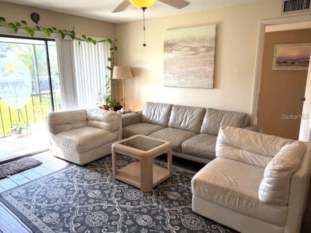 108 Nina Way, Unit 3 Oldsmar, FL 34677 - Photo 6 of 25 a living room with furniture and a large window