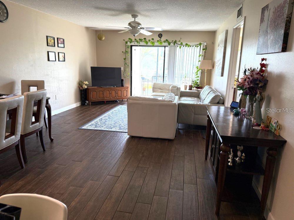 108 Nina Way, Unit 3 Oldsmar, FL 34677 - Photo 7 of 25 a living room with furniture and a flat screen tv
