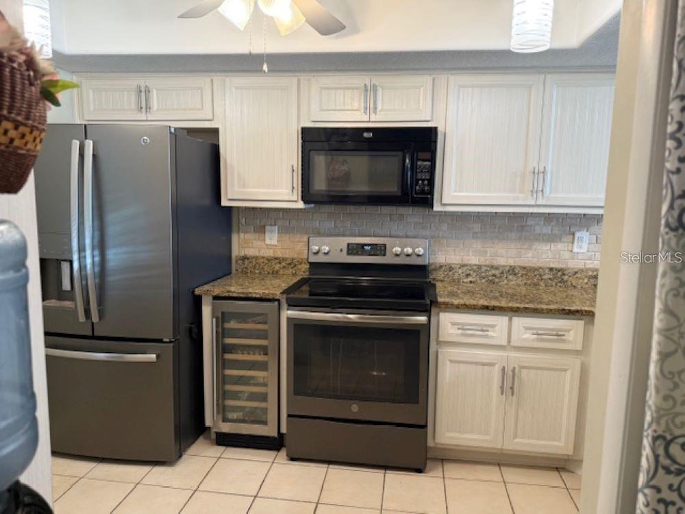 108 Nina Way, Unit 3 Oldsmar, FL 34677 - Photo 10 of 25 a kitchen with cabinets stainless steel appliances and a counter space