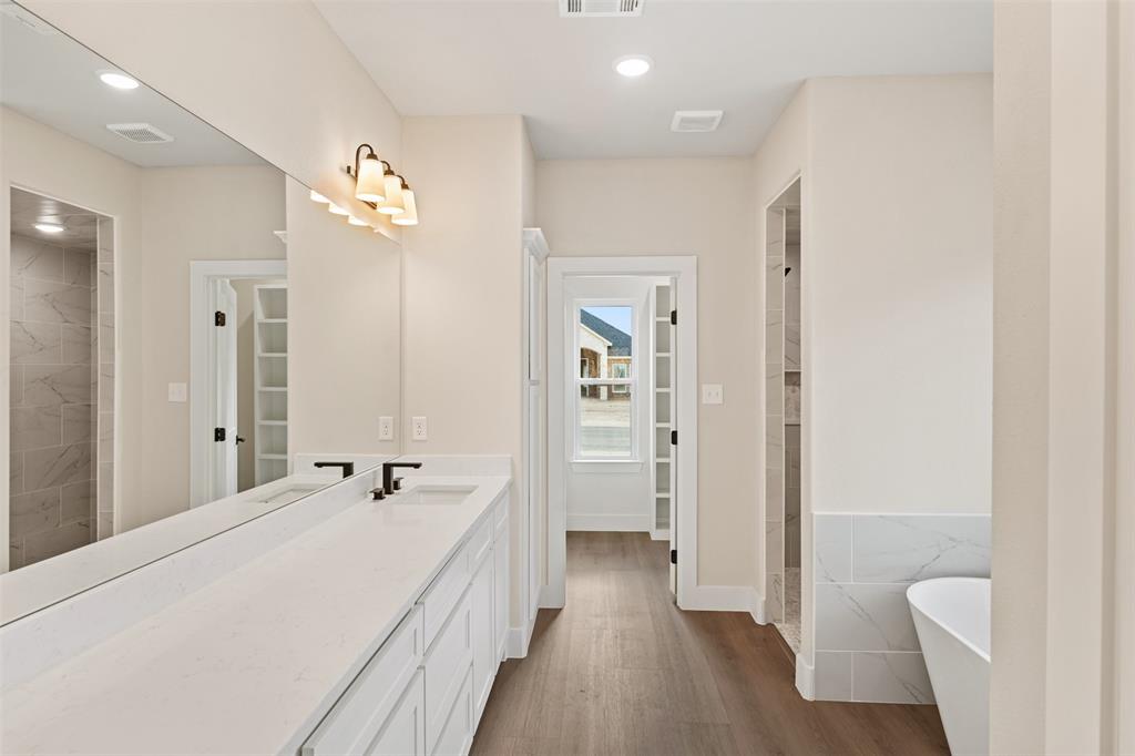 506 Limestone Circle Mabank, TX 75147 - Photo 14 of 33 a spacious bathroom with a double vanity sink a mirror and a shower
