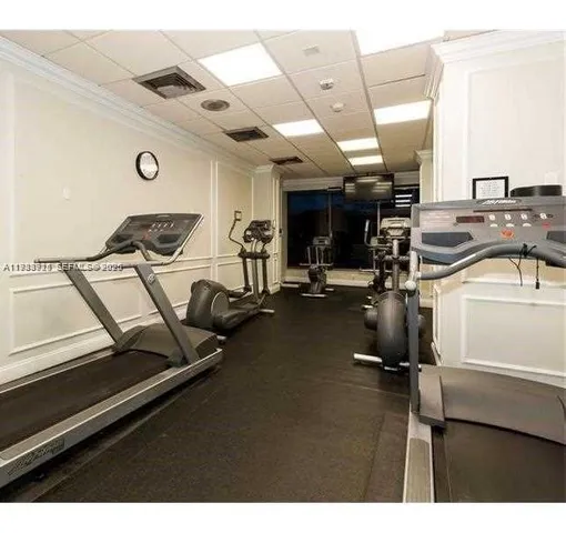a view of kitchen with stove and refrigerator