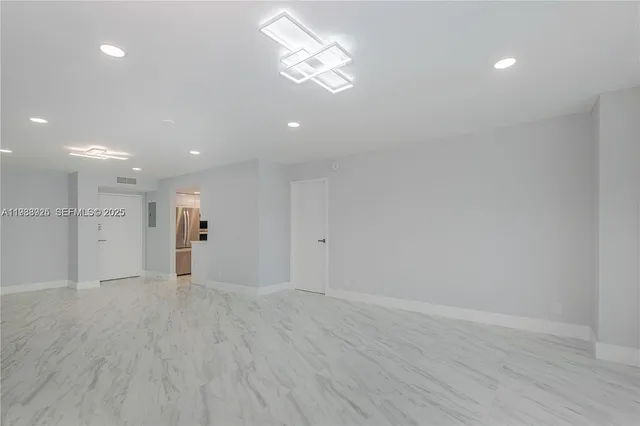 a view of a room with wooden floor and a ceiling fan