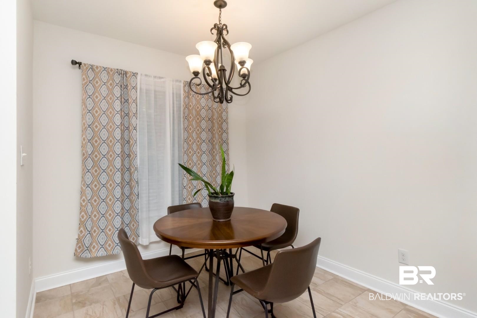 10714 Brodick Loop Spanish Fort, AL 36527 - Photo 9 of 26 Dining area with a chandelier and baseboards