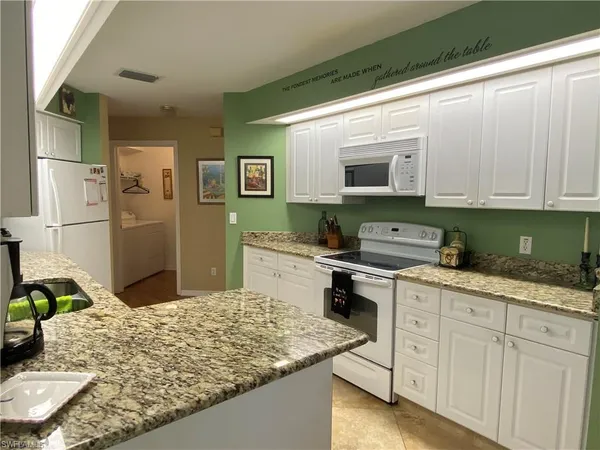 a kitchen with stainless steel appliances granite countertop a sink and a stove