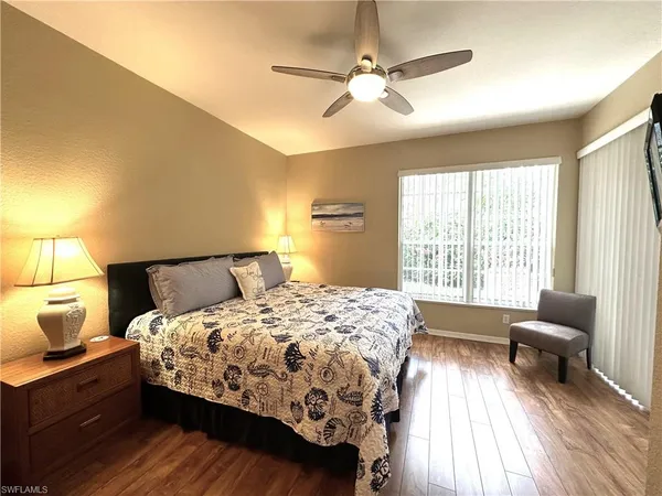 a bedroom with a bed a couch and dresser