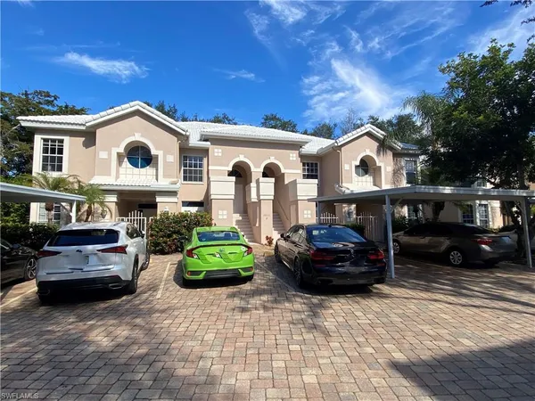 a front view of a house with parking space