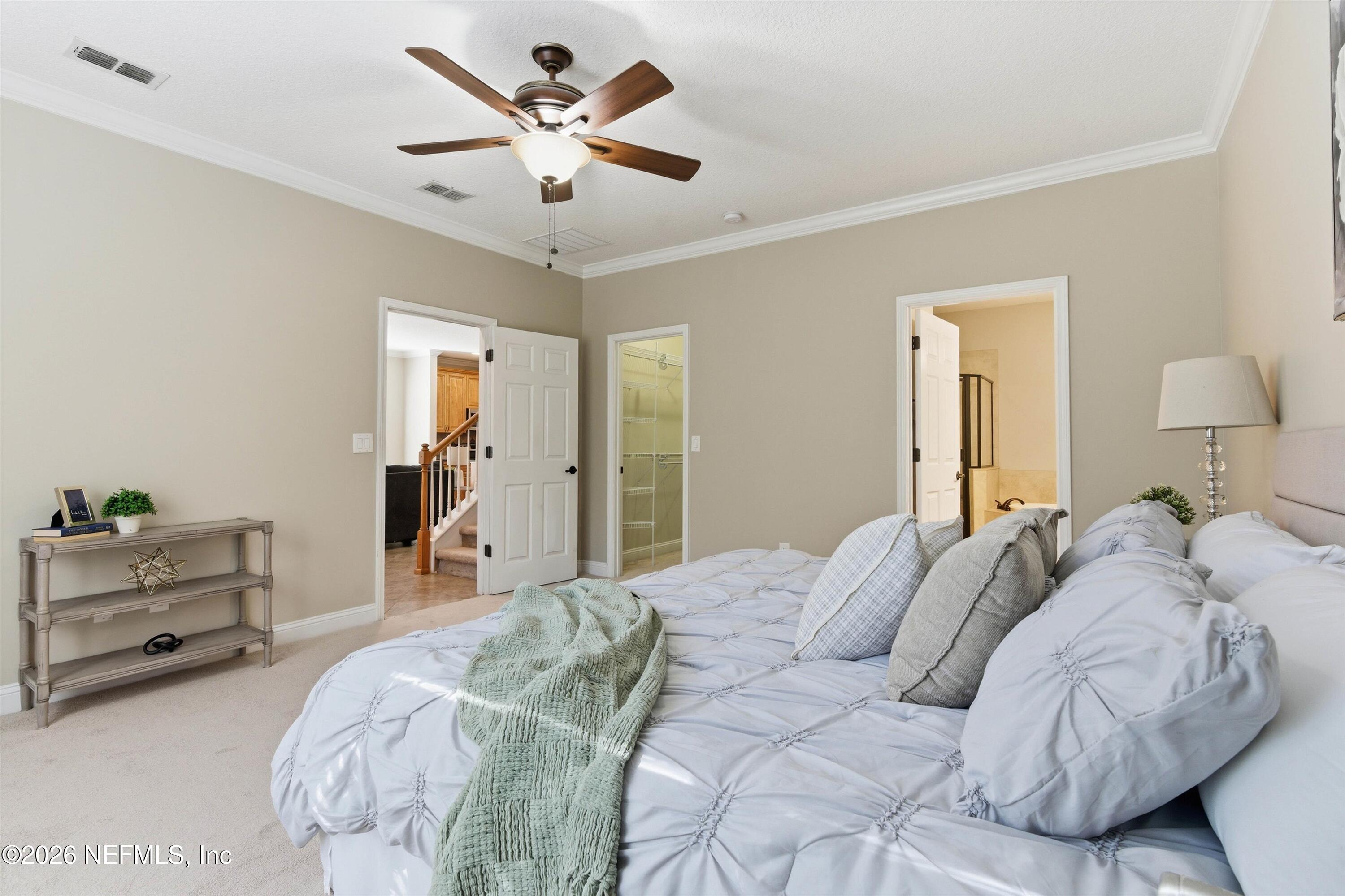 1733 Sanctuary Way Fleming Island, FL 32003 - Photo 16 of 39 a bedroom with a bed and a chandelier