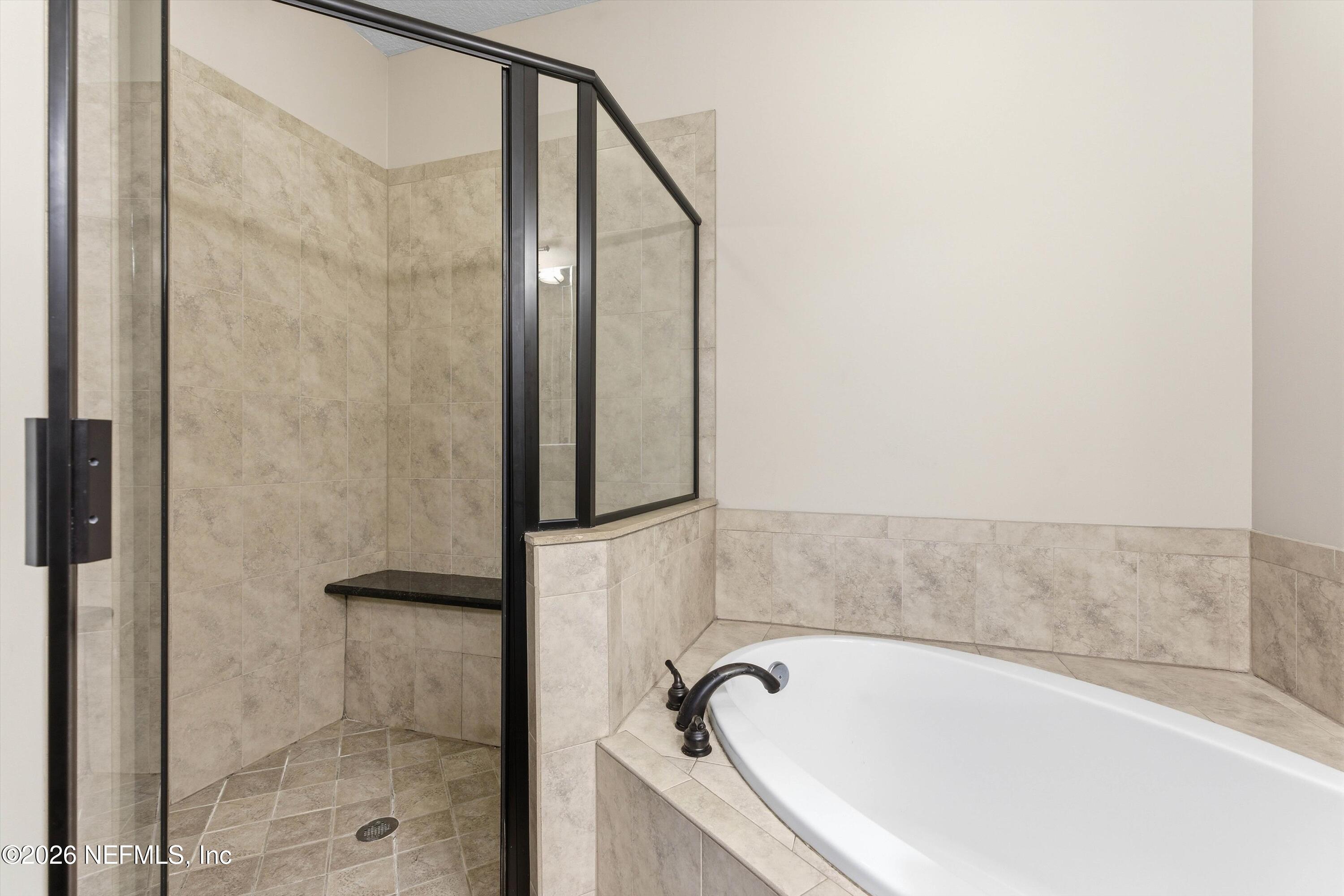 1733 Sanctuary Way Fleming Island, FL 32003 - Photo 19 of 39 a bathroom with shower and bathtub