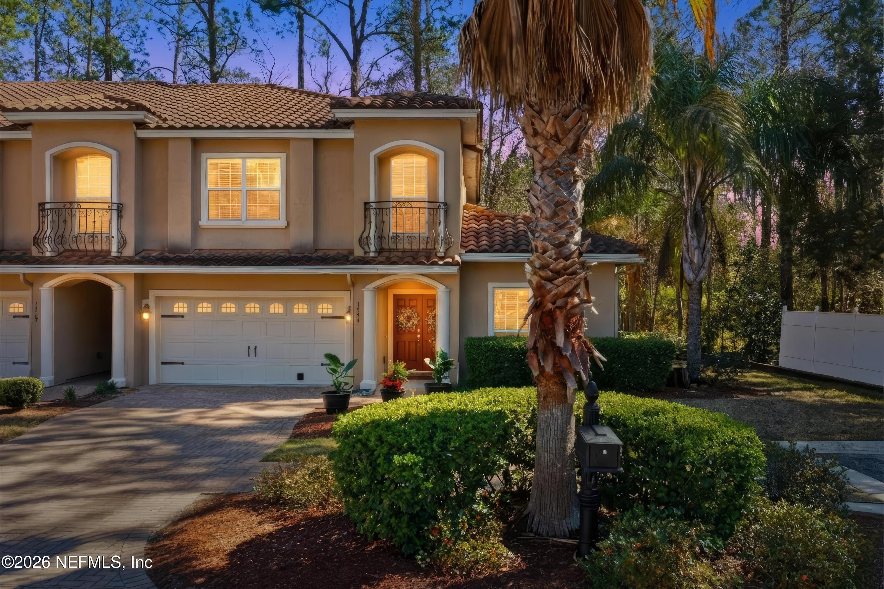 1733 Sanctuary Way Fleming Island, FL 32003 - Photo 2 of 39 a front view of a house with garden