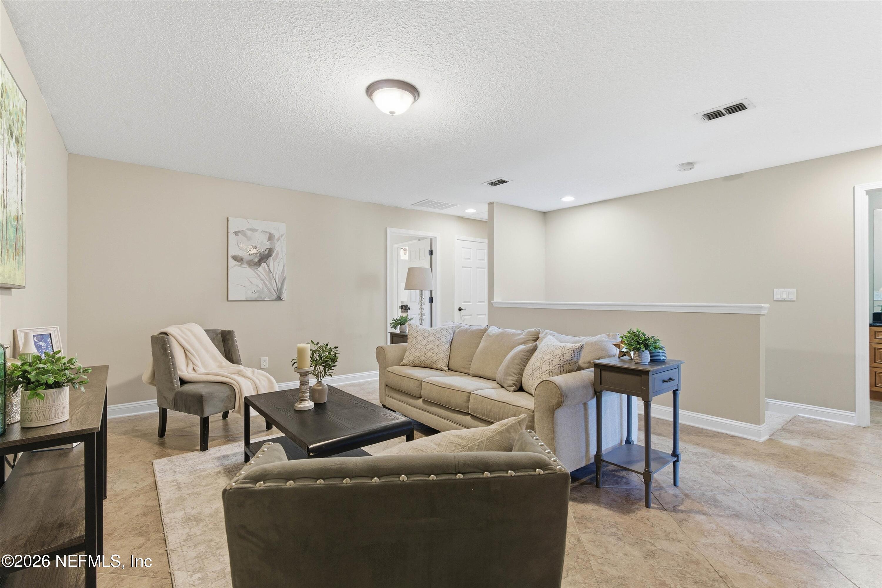 1733 Sanctuary Way Fleming Island, FL 32003 - Photo 21 of 39 a living room with furniture and wooden floor