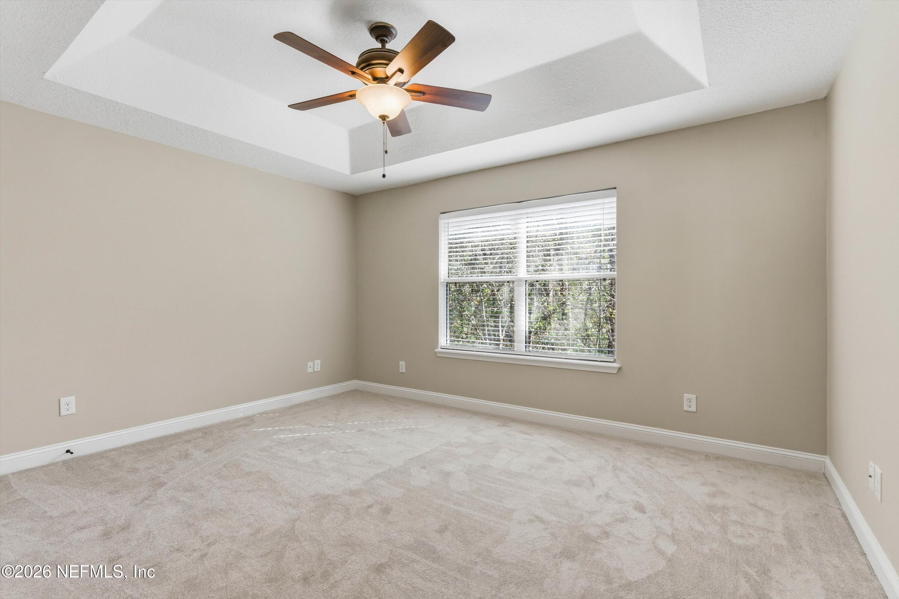 1733 Sanctuary Way Fleming Island, FL 32003 - Photo 22 of 39 an empty room with a window and a fan