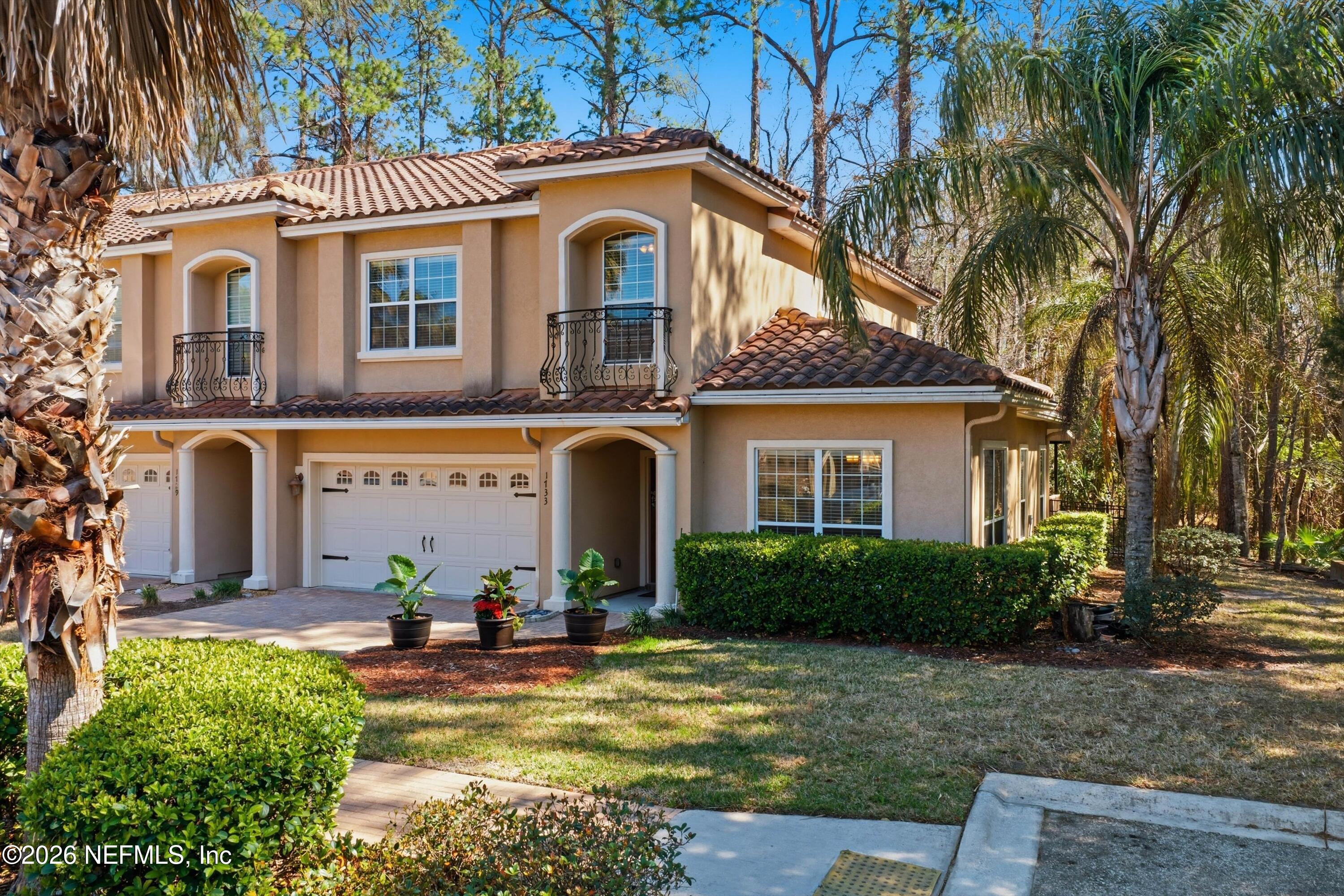 1733 Sanctuary Way Fleming Island, FL 32003 - Photo 24 of 39 a front view of a house with garden